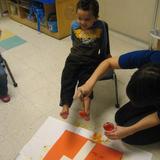 Maray Drive KinderCare Photo #8 - Our Preschool children painting the letter T with their toes.