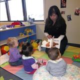 Highland KinderCare Photo #7 - Listening to story time.