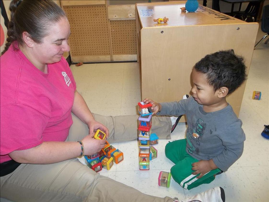 Highland KinderCare Photo #1 - Stacking blocks with his teacher.