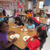 Wildflower Lane KinderCare Photo #7 - Kindergarteners making faces out of healthy food