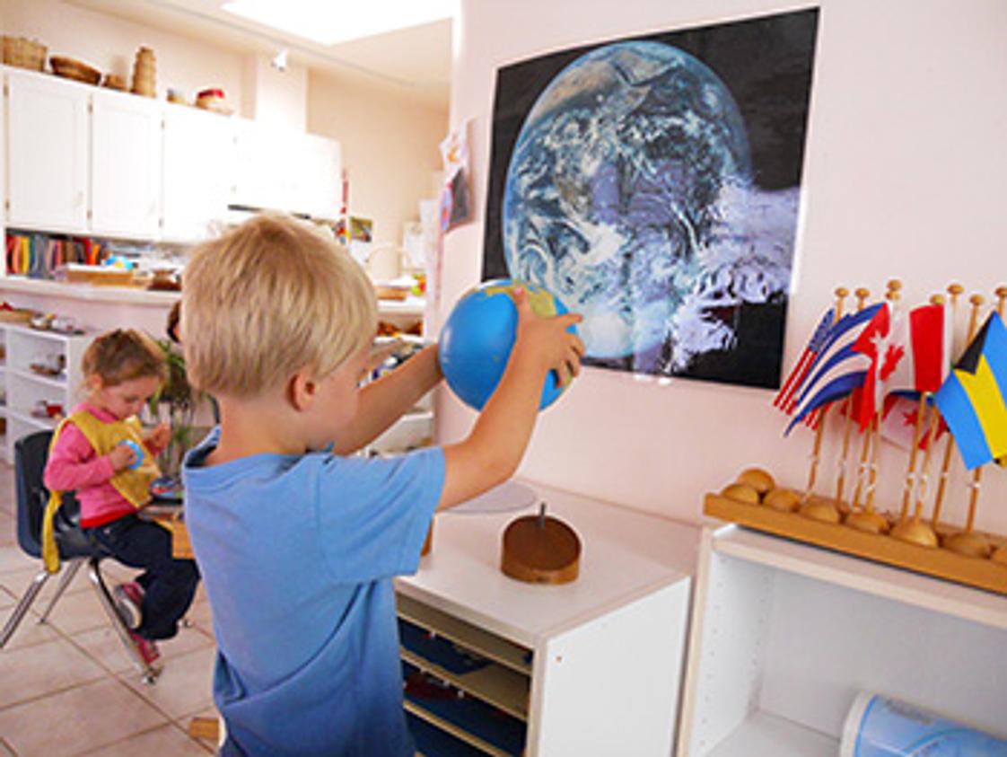 Childrens Garden Montessori Photo - Boy with globe