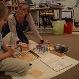 International Montessori School Photo #4 - A French Elementary student receiving a lesson in long division.