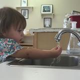 Our World Montessori Photo - Focusing on washing hands - 15 months old