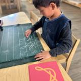 Mountain West Montessori Photo #8 - The sound is " sssssssss " is felt ( through the sandpaper letters), seen ( also as the child is tracing the letter) and heard ( when we sound the letter as we trace it.) Fun right!! This is multi sensorial learning, powerful way to learn. ;)