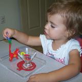 Live Oak Montessori School Photo #2 - Our two-year old is working in Practical Life area on mastering her fine motor skills.