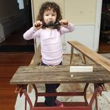 Longview School Photo - Our youngest student, 4 year old Maizie, is sanding their collaborative woodworking project.