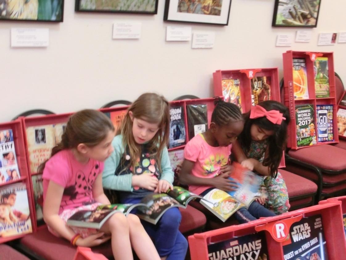 Las Cruces Academy Photo #1 - Kindergarteners diving into new books at our in-house book fair