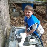 Boulder Knoll Montessori School Photo #5 - Washing objects in the Outdoor Classroom.