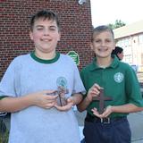 Holy Cross School Photo #8 - Zachary and Nicholas Klaus holding the crosses that were made from the marble flooring of The World Trade Center that were given to Mrs. O'Mara's aunt in remembrance of her husband's sacrifice and commitment to being a First Responder of 9/11.(Photo taken by Mike Lang photographer of The Dialog)