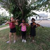 Hill Country Arts Academy Photo - Students setting up to practice music outside