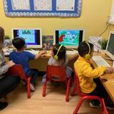 Village Preschool Academy Photo #4 - In our computer lab, children build essential hand-eye coordination as they learn to navigate the mouse and keyboard. Developing these foundational tech skills early prepares them for the increasing use of computers in elementary school and beyond.