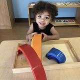 Children's House Montessori School Photo #5 - This lesson teaches toddlers colors, sorting by size, and also works on their fine motor skills.