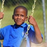 Lake Rose Christian Academy Photo #5 - A Lake Rose Christian Academy student enjoys a moment on the playground, holding the swing with a look of focus and excitement.