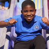 Lake Rose Christian Academy Photo #3 - A Lake Rose Christian Academy student enjoys time on the playground, smiling as he slides down with energy and excitement.