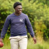 Lake Rose Christian Academy Photo #11 - A Lake Rose Christian Academy student takes part in athletic activity on campus, carrying a football as he enjoys time outdoors.