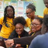 Lake Rose Christian Academy Photo #9 - A Lake Rose Christian Academy teacher works closely with a group of students, guiding them through a collaborative classroom activity.