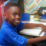 Lake Rose Christian Academy Photo #6 - A Lake Rose Christian Academy student works attentively at his desk, focused on a hands-on classroom activity while smiling with confidence.