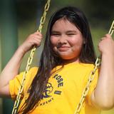Lake Rose Christian Academy Photo #16 - A Lake Rose Christian Academy student enjoys time on the playground, smiling as she swings in the sunshine.