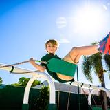 Pine Crest School Photo - Lower School student swinging while on the playground.