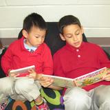 Savannah Adventist Christian School Photo #3 - Reading Buddies. Here, a third grade student shares a great story with a preschooler.