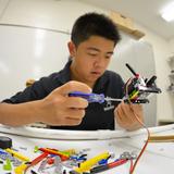 Hanalani Schools Photo - Hanalani has a highly successful robotics program that contributed to two International Championship and 4 Regional Championship Botball teams. Here a student builds a robot from the multitude of parts and tools at his disposal.