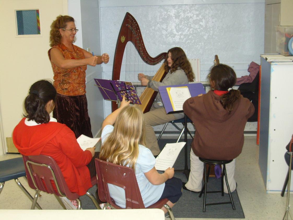 Allegro Academy Photo #1 - Our harpists listen to instructor and Rockford Symphony harpist Ms. Felix.
