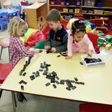 St. John Lutheran Early Learning Center Photo #9 - Manipulatives help children learn math concepts and operations. Here dominoes are being used for that purpose.