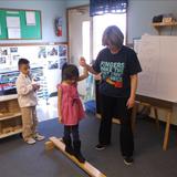 Bensenville KinderCare Photo #1 - Walking with Ms. Arlene on the balance beam, great gross motor fun!