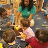 Meyers Road KinderCare Photo #1 - Our toddler class guessing what they will find in the mystery box.